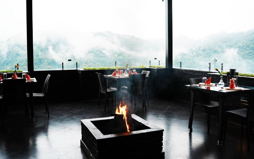 Elegant outdoor seating area with firepit at a 5-star hotel in Munnar.
