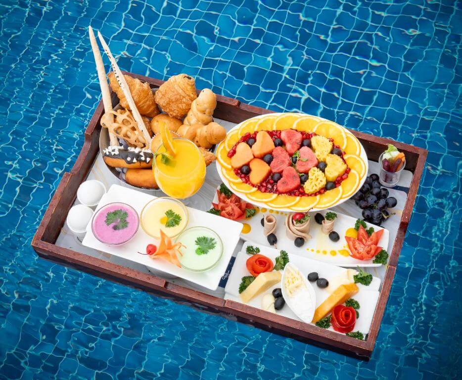 Luxury floating breakfast tray in a pool at a 5 star resort in Munnar.