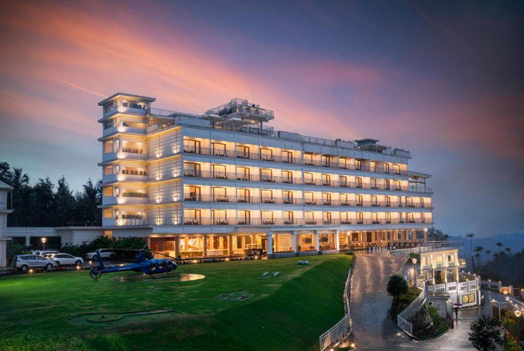 Scenic sunset view from a 5-star resort balcony in Munnar.
