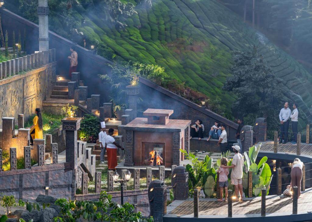 Cozy seating area with a fireplace at a Munnar 5-star hotel.