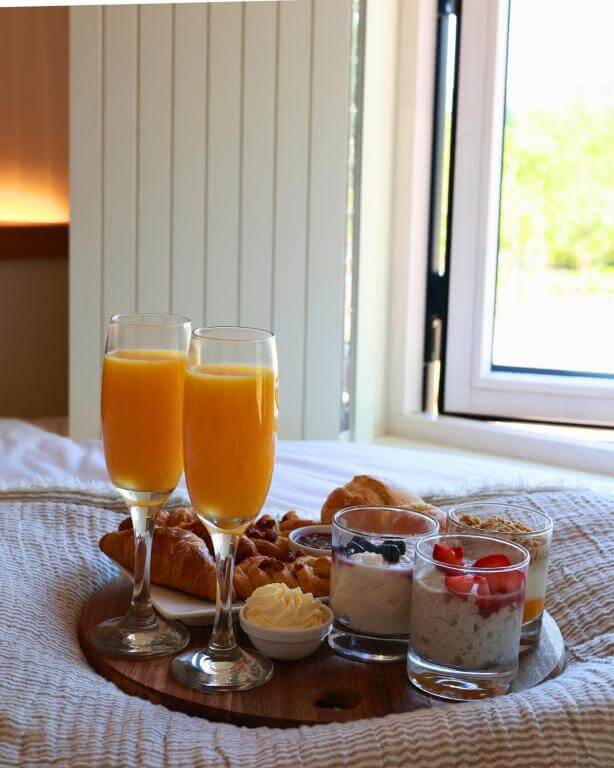 Irish breakfast served in the cabin with coffee, fruit, and pastries — perfect start to a stay in a luxury cabin in Ireland.