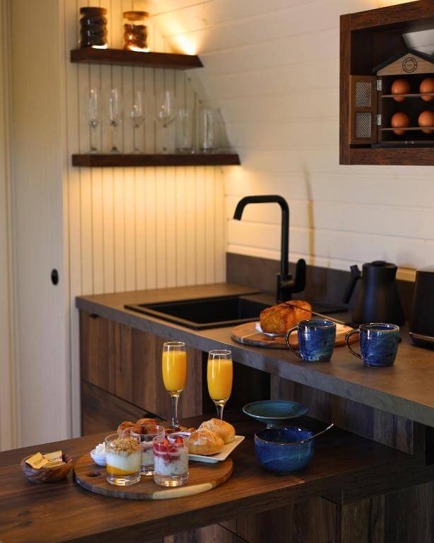 Cabin kitchenette stocked with coffee, fresh milk, and local treats at Ballygarry Estate in Ireland.