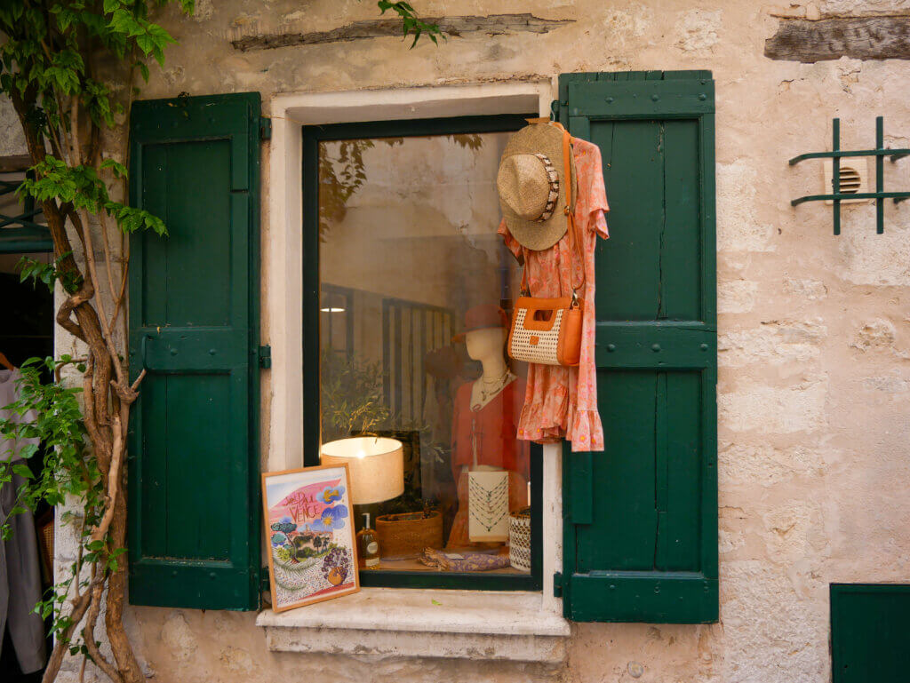Shops with handmade crafts along cobbled street in Saint Paul de Vence