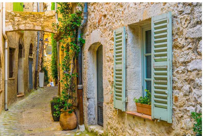 Traditional French shutters on cobbled street in Saint Paul de Vence