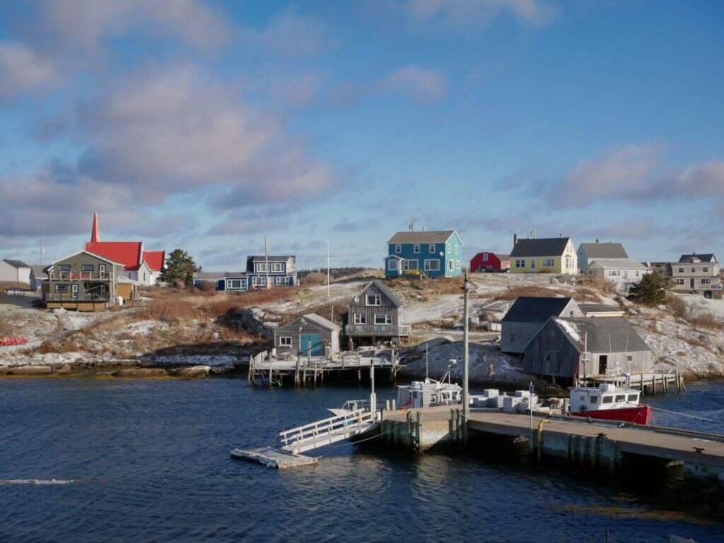 Colourful fishing shacks surrounding the harbour at Peggy's Cove on a winter day