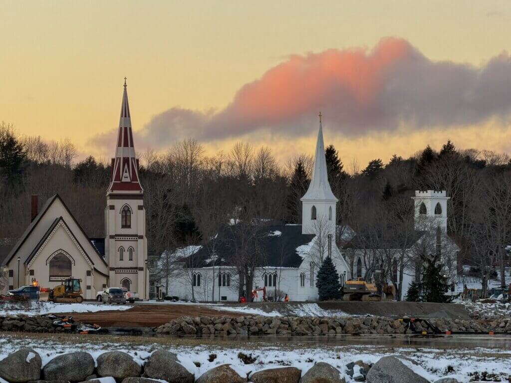 Three churches in Mahone Bay, Nova Scotia, at sunset.