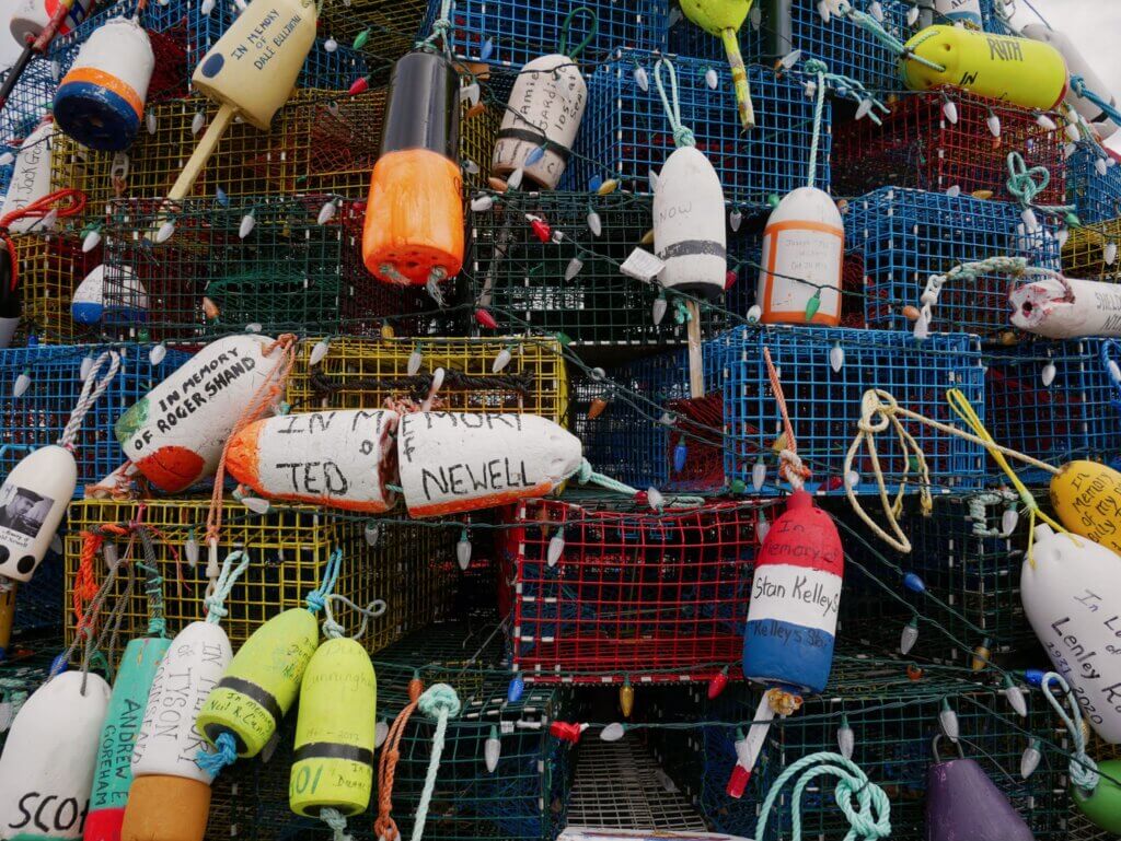 Close up shot of the memorial buoys on the Cape Sable Island lobster trap Christmas tree in Barrington, Nova Scotia.